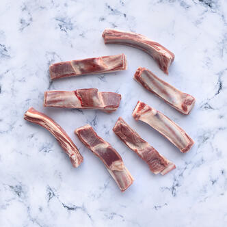 lamb riblets on marble background