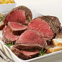 Two medium rare USDA Prime Beef Tenderloin sliced on a serving plate.