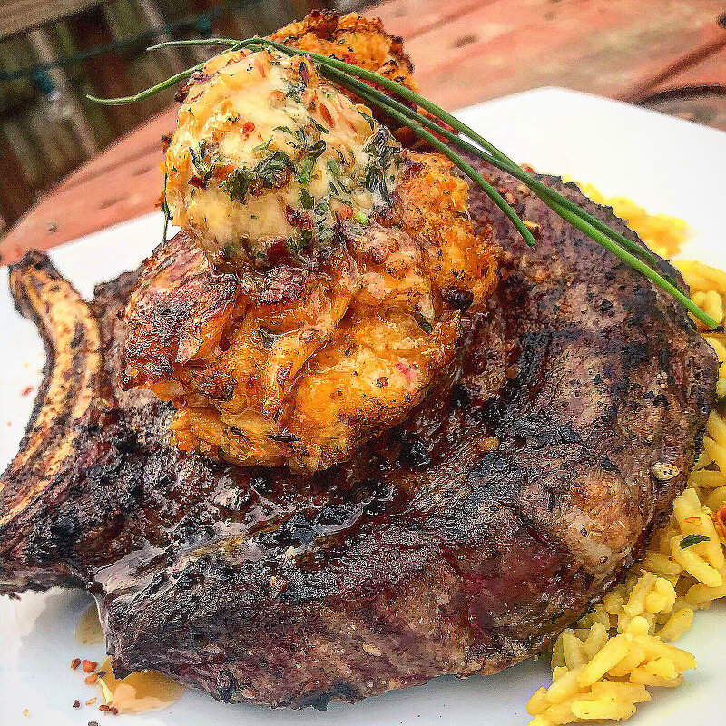Grilled Ribeye with Smoked Creole Butter and Crawfish Crab Cakes